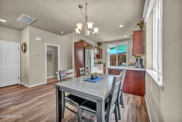 3678 Hollywood Park Dr, Reno, NV 89512 - dining area with light wood-type flooring, a chandelier, baseboards, and recessed lighting