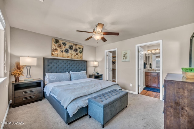 3678 Hollywood Park Dr, Reno, NV 89512 - carpeted bedroom with baseboards, a spacious closet, a closet, ensuite bath, and ceiling fan