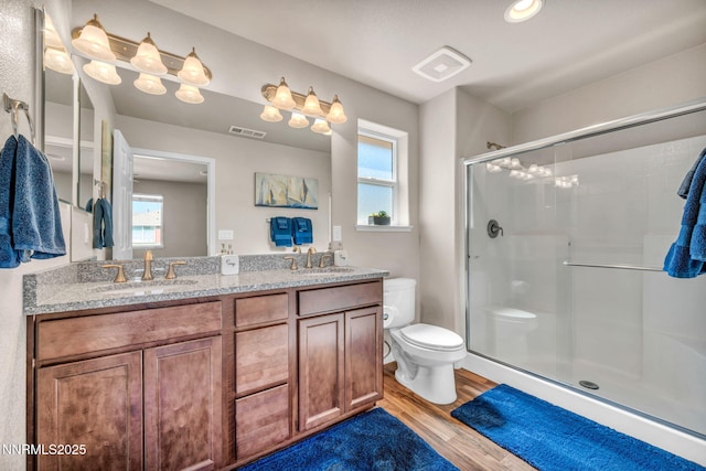 3678 Hollywood Park Dr, Reno, NV 89512 - bathroom with toilet, wood finished floors, a stall shower, and double vanity