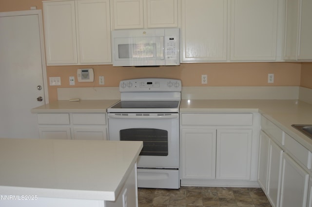 7890 Key Largo Dr, Reno, NV 89506 - kitchen featuring white appliances, white cabinets, and light countertops