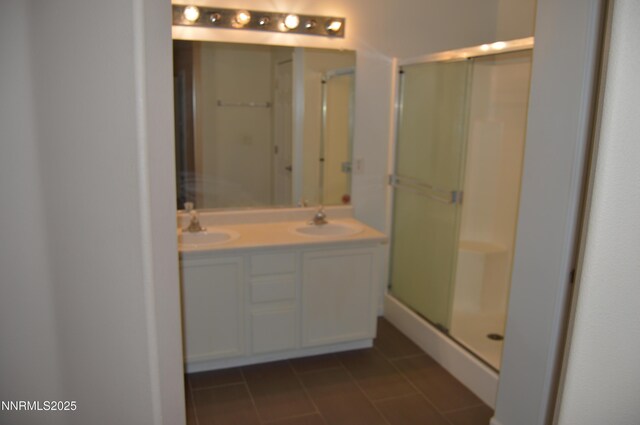 7890 Key Largo Dr, Reno, NV 89506 - bathroom featuring a shower stall, double vanity, and tile patterned flooring
