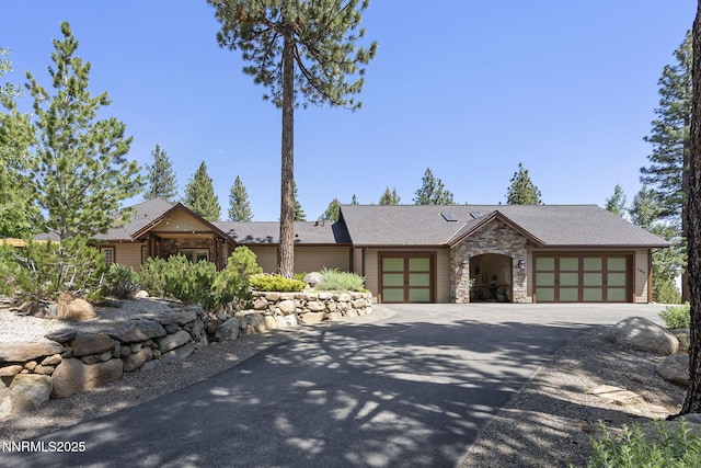 165 Piney Creek Rd, Reno, NV 89511 - mid-century modern home with driveway, an attached garage, and stone siding