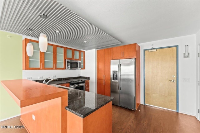 255 N Sierra St Unit 1709, Reno, NV 89501 - kitchen featuring stainless steel appliances, brown cabinetry, a peninsula, glass insert cabinets, and dark wood-style floors