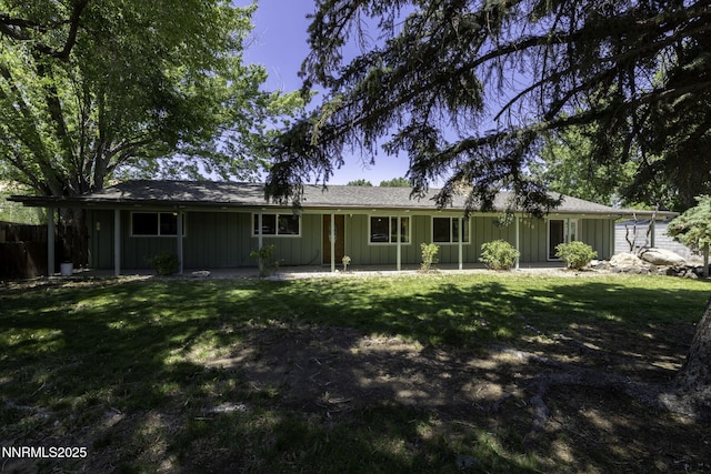 4879 Idlewild Dr, Reno, NV 89519 - back of property with board and batten siding, a lawn, and a patio area