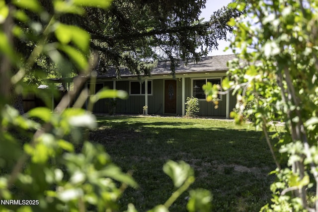 4879 Idlewild Dr, Reno, NV 89519 - rear view of property featuring board and batten siding and a yard