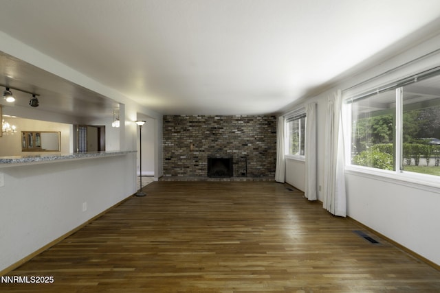 4879 Idlewild Dr, Reno, NV 89519 - unfurnished living room featuring wood finished floors and a fireplace