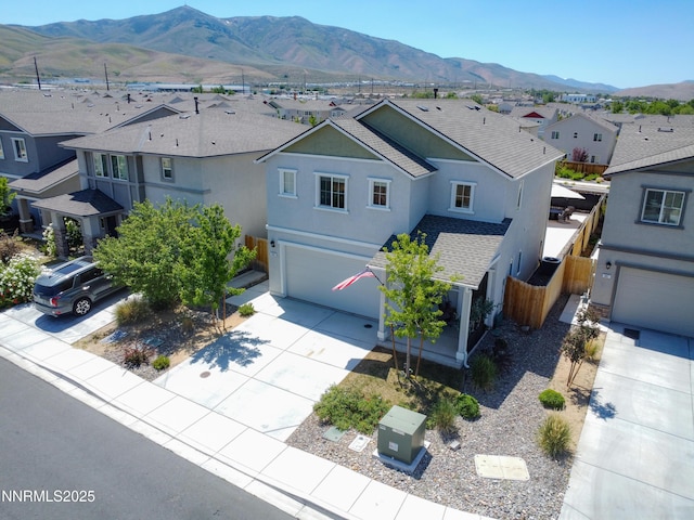 503 Astraea Trl, Reno, NV 89506 - view of front facade featuring a residential view, a garage, stucco siding, driveway, and a mountain view
