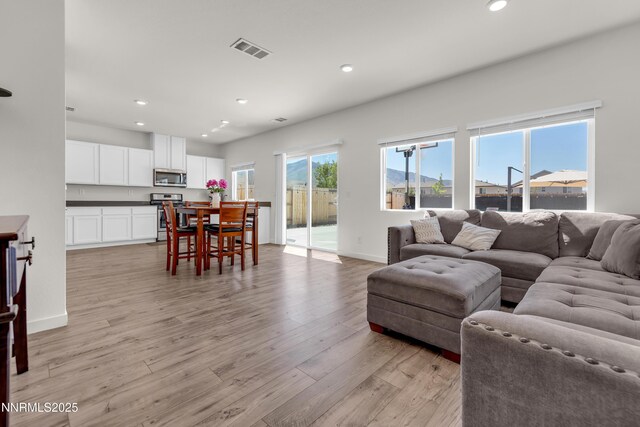 503 Astraea Trl, Reno, NV 89506 - living room with recessed lighting, light wood-style flooring, and baseboards
