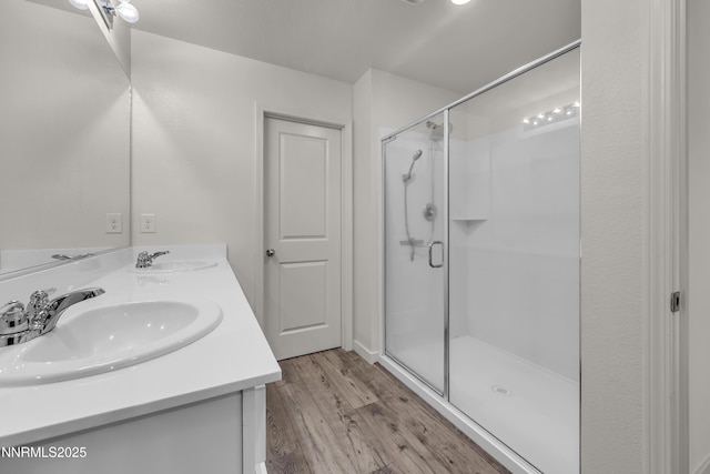 503 Astraea Trl, Reno, NV 89506 - full bath featuring double vanity, a shower stall, and wood finished floors
