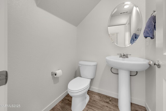 503 Astraea Trl, Reno, NV 89506 - half bath with toilet, wood finished floors, lofted ceiling, and baseboards