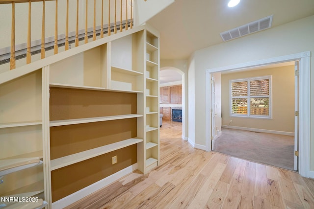 6978 Poco Bueno Cir, Sparks, NV 89436 - corridor featuring arched walkways, baseboards, and wood finished floors