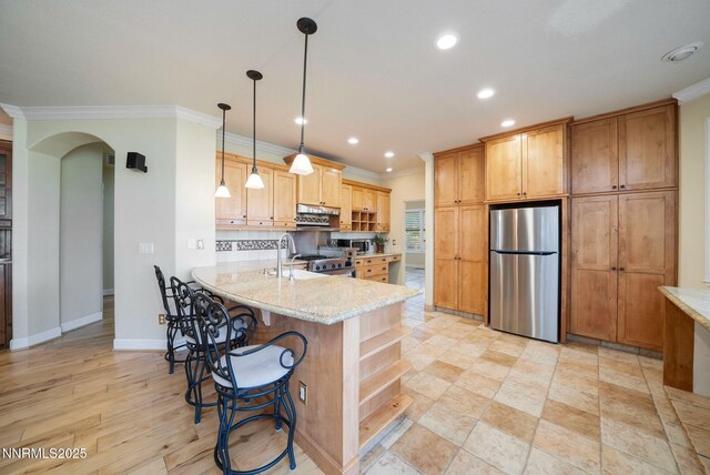 6978 Poco Bueno Cir, Sparks, NV 89436 - kitchen featuring freestanding refrigerator, crown molding, recessed lighting, a peninsula, and arched walkways