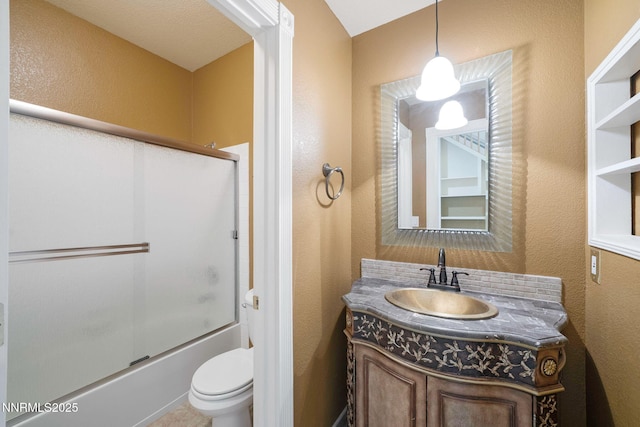 6978 Poco Bueno Cir, Sparks, NV 89436 - full bathroom with a textured wall, vanity, toilet, and bath / shower combo with glass door