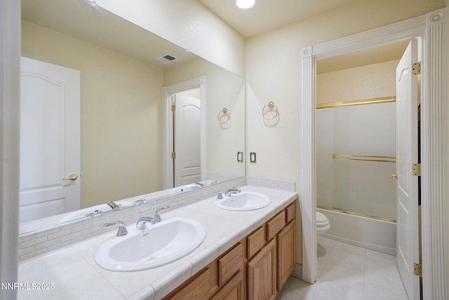 6978 Poco Bueno Cir, Sparks, NV 89436 - full bath with toilet, double vanity, tile patterned floors, and enclosed tub / shower combo