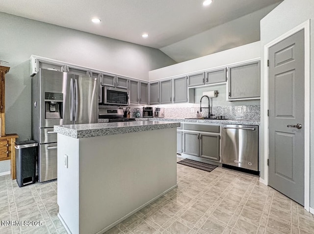 602 Tamsen Rd, Fernley, NV 89408 - kitchen with appliances with stainless steel finishes, a sink, gray cabinetry, lofted ceiling, and a center island