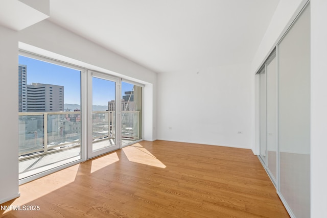 255 N Sierra St Unit 1210, Reno, NV 89501 - unfurnished room with a city view and light wood-type flooring