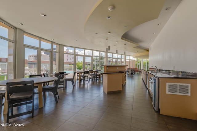 255 N Sierra St Unit 1210, Reno, NV 89501 - kitchen featuring expansive windows, dark countertops, healthy amount of natural light, dark tile patterned floors, and a kitchen island