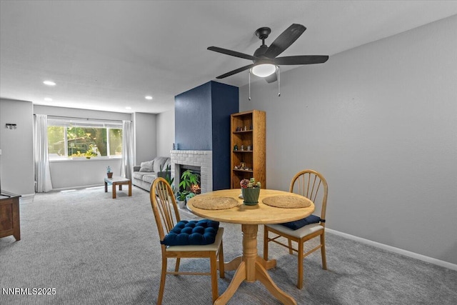 423 Barclay Ct, Reno, NV 89511 - carpeted dining room with a ceiling fan, a brick fireplace, recessed lighting, and baseboards
