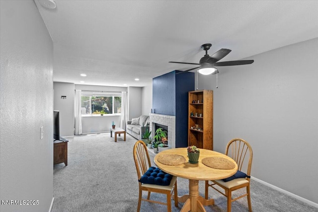 423 Barclay Ct, Reno, NV 89511 - carpeted dining room with a fireplace, ceiling fan, baseboards, and recessed lighting
