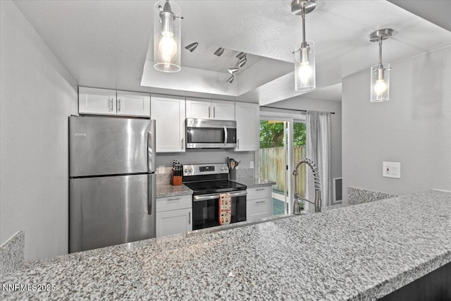 423 Barclay Ct, Reno, NV 89511 - kitchen with stainless steel appliances, white cabinets, light stone counters, decorative light fixtures, and a textured ceiling