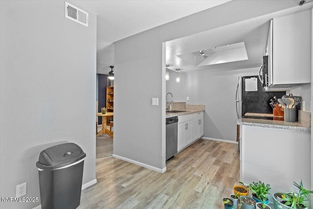 423 Barclay Ct, Reno, NV 89511 - kitchen featuring a sink, appliances with stainless steel finishes, light wood-style floors, white cabinetry, and baseboards