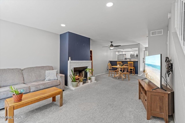 423 Barclay Ct, Reno, NV 89511 - living area featuring a ceiling fan, carpet flooring, a brick fireplace, and recessed lighting
