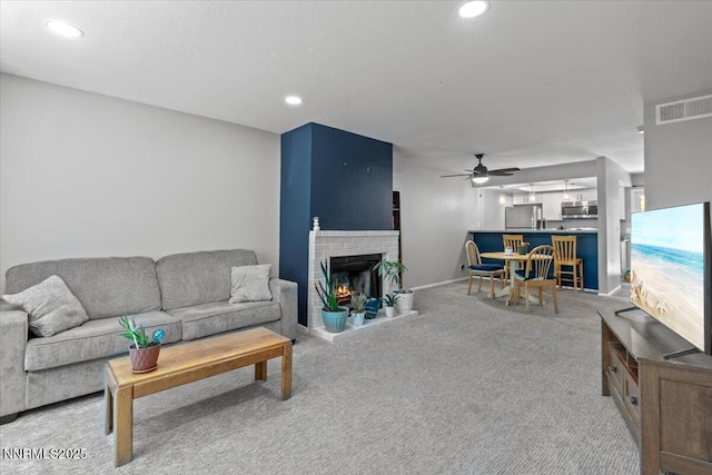 423 Barclay Ct, Reno, NV 89511 - living area featuring light carpet, a ceiling fan, recessed lighting, and a fireplace
