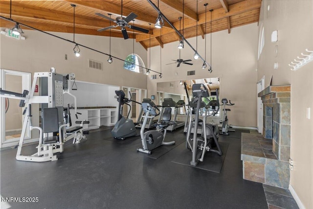 423 Barclay Ct, Reno, NV 89511 - workout area with a ceiling fan, wood ceiling with exposed beams, high vaulted ceiling, a tiled fireplace, and baseboards