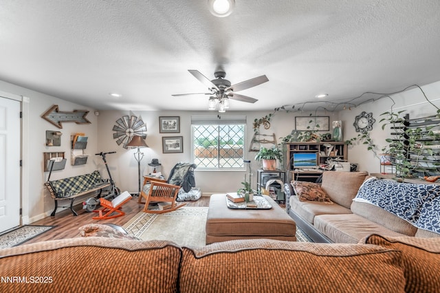9365 Gremlin Way, Reno, NV 89506 - living area with wood finished floors, a ceiling fan, a textured ceiling, baseboards, and recessed lighting