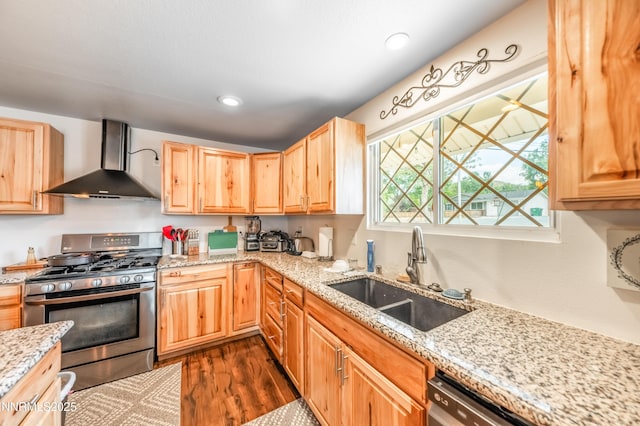 9365 Gremlin Way, Reno, NV 89506 - kitchen featuring stainless steel range with gas cooktop, wall chimney range hood, a sink, dark wood-type flooring, and light brown cabinetry