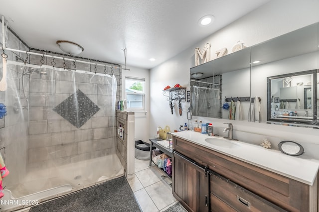 9365 Gremlin Way, Reno, NV 89506 - bathroom with a stall shower, tile patterned flooring, vanity, and recessed lighting