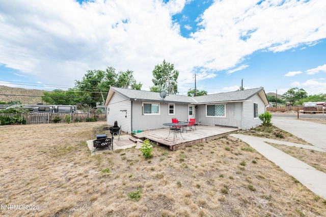 9365 Gremlin Way, Reno, NV 89506 - back of house with a wooden deck and a fire pit