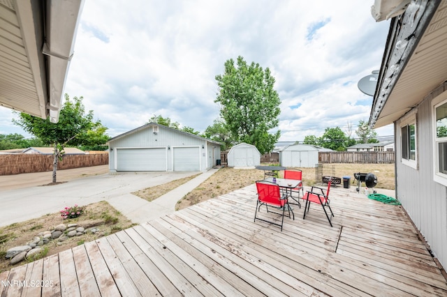 9365 Gremlin Way, Reno, NV 89506 - wooden deck featuring outdoor dining space, a fenced backyard, and a garage