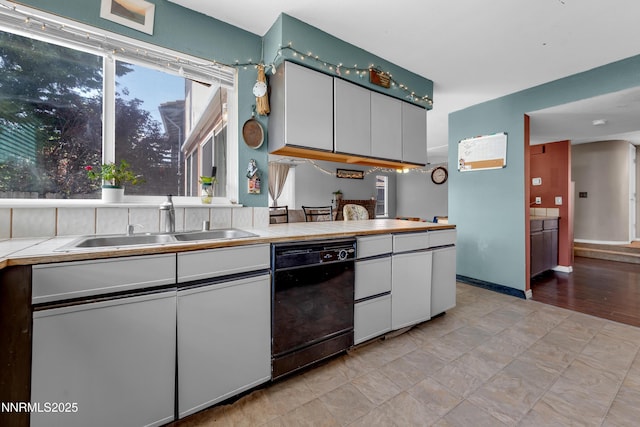 7090 Peppermint Dr, Reno, NV 89506 - kitchen featuring black dishwasher, a sink, white cabinetry, and tile countertops