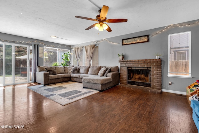7090 Peppermint Dr, Reno, NV 89506 - living area featuring wood finished floors, a textured ceiling, a ceiling fan, a fireplace, and baseboards