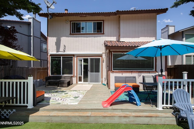 7090 Peppermint Dr, Reno, NV 89506 - back of property with a deck and a tile roof