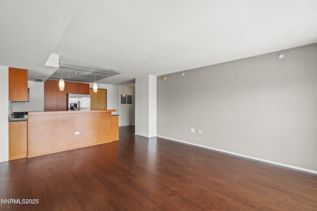 255 N Sierra St Unit 2113, Reno, NV 89501 - unfurnished living room with dark wood-type flooring and baseboards