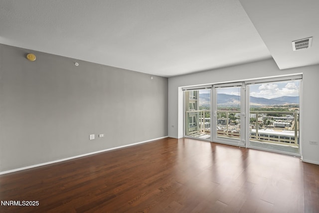 255 N Sierra St Unit 2113, Reno, NV 89501 - empty room featuring wood finished floors, a mountain view, and a smoke detector