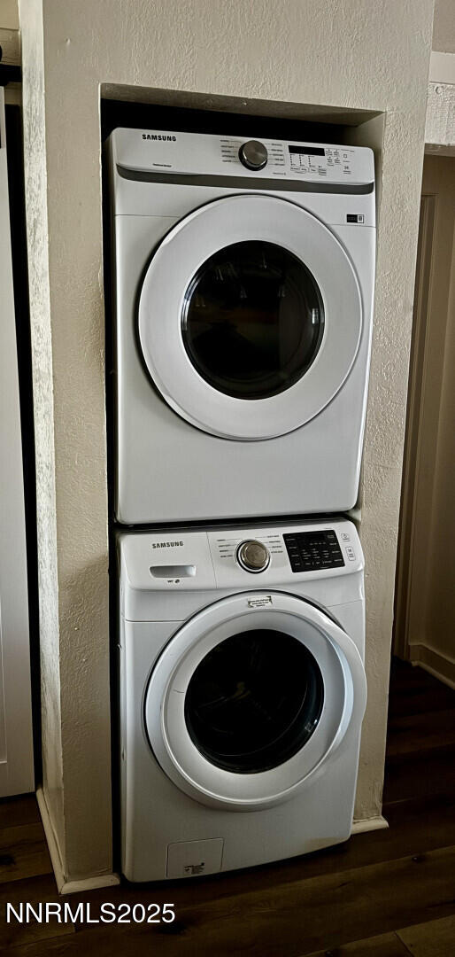 810 Alder Ave Unit 61, Incline Village, NV 89451 - laundry room featuring stacked washing machine and dryer, wood finished floors, and a textured wall