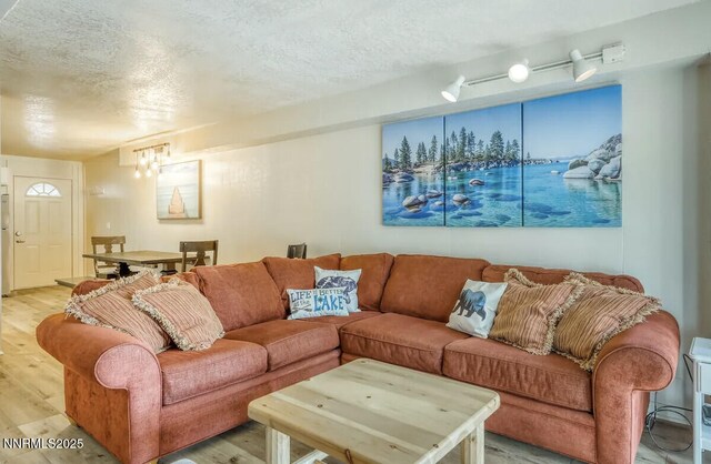 810 Alder Ave Unit 61, Incline Village, NV 89451 - living area featuring light wood-style floors, a chandelier, and a textured ceiling