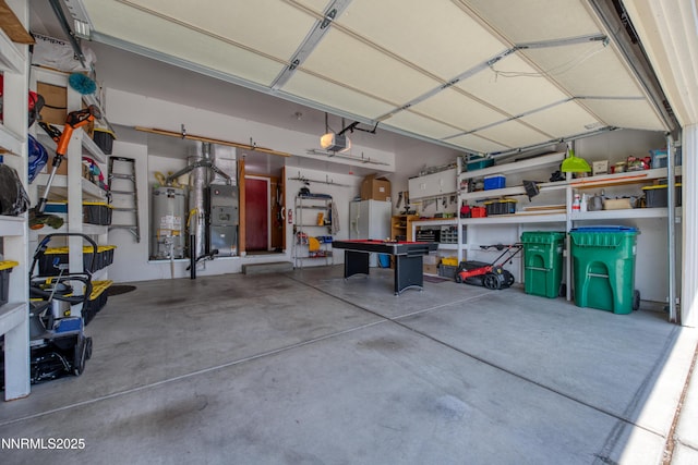 799 Caughlin Gln, Reno, NV 89519 - garage featuring a garage door opener, strapped water heater, white fridge with ice dispenser, heating unit, and a workshop area
