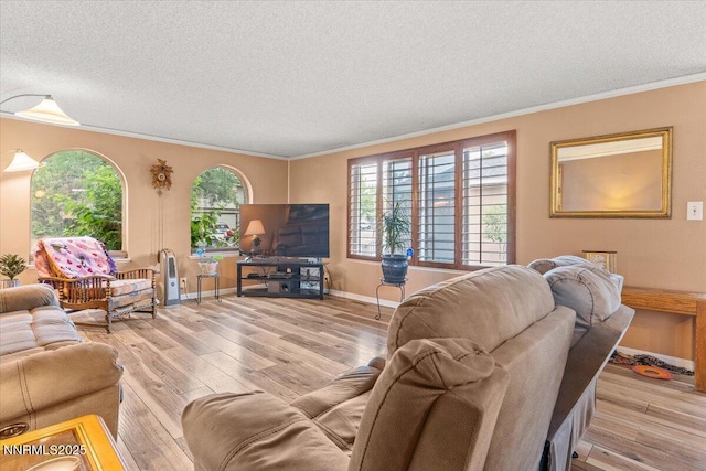 4415 Leche Way, Reno, NV 89502 - living room featuring a textured ceiling, light wood-style floors, healthy amount of natural light, ornamental molding, and baseboards