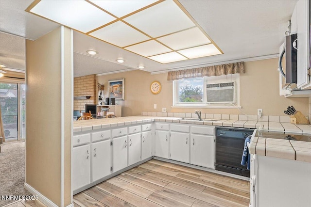 4415 Leche Way, Reno, NV 89502 - kitchen with black dishwasher, stainless steel microwave, tile countertops, a sink, and white cabinets