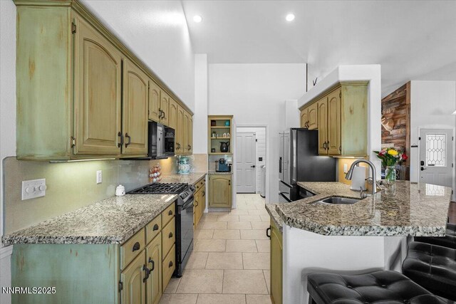 1055 Golden Park Way, Fallon, NV 89406 - kitchen featuring black appliances, a sink, a peninsula, light stone counters, and a breakfast bar