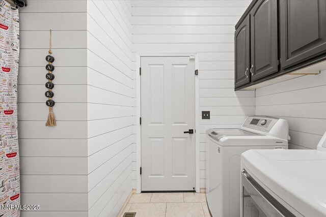 1055 Golden Park Way, Fallon, NV 89406 - laundry room with separate washer and dryer, cabinet space, wood walls, and light tile patterned flooring