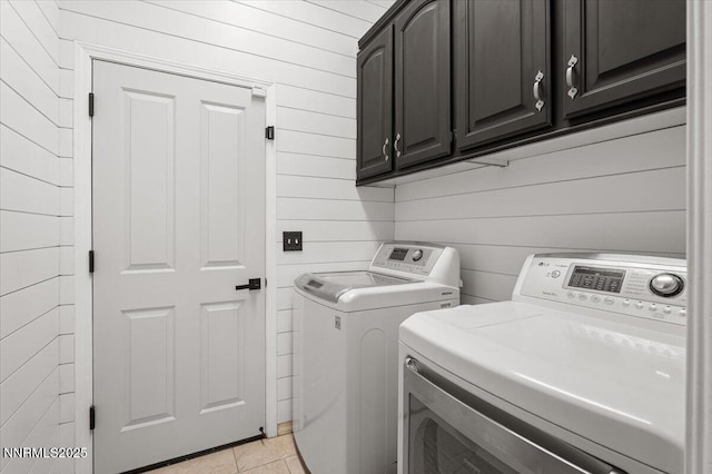1055 Golden Park Way, Fallon, NV 89406 - laundry room featuring washer and clothes dryer, cabinet space, wood walls, and light tile patterned floors