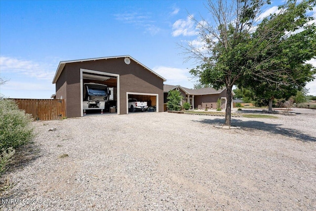 1055 Golden Park Way, Fallon, NV 89406 - view of side of property with stucco siding and a detached garage