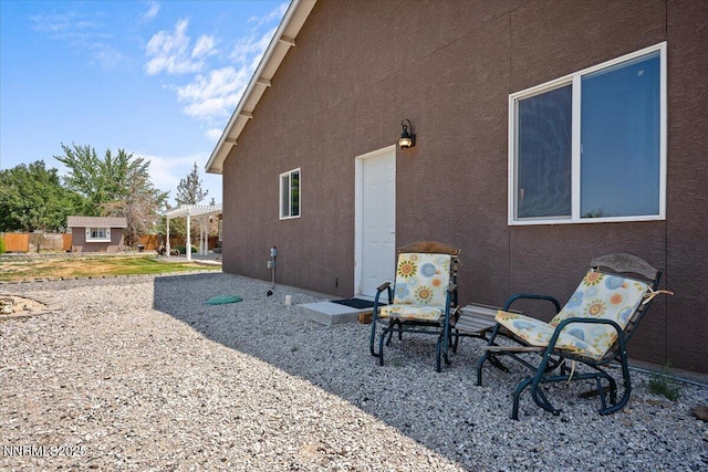 1055 Golden Park Way, Fallon, NV 89406 - back of property with stucco siding, a patio, and an outdoor structure