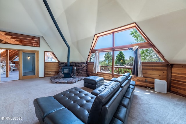 15118 N Timberline Dr, Reno, NV 89511 - carpeted living area with wooden walls, vaulted ceiling, a wood stove, and plenty of natural light