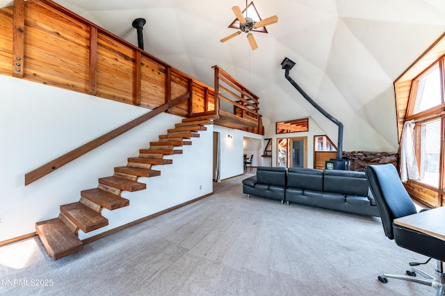 15118 N Timberline Dr, Reno, NV 89511 - carpeted living area featuring high vaulted ceiling, ceiling fan, stairs, and a wood stove